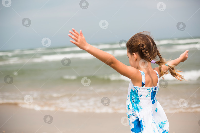 Скачать Портрет девушки на берегу моря. Ребенок наслаждается волнами, отдыхом на пляже, путешествиями. фотосток Ozero
