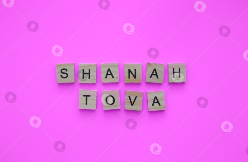 Скачать September 15-17, Rosh Hashanah, minimalistic banner with the inscription in wooden letters on a pink background фотосток Ozero