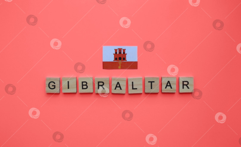 Скачать September 10, Gibraltar National Day, flag of Gibraltar, minimalistic banner with the inscription in wooden letters фотосток Ozero