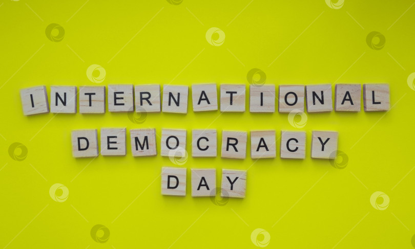 Скачать September 15, International Day of Democracy, minimalistic banner with the inscription in wooden letters фотосток Ozero