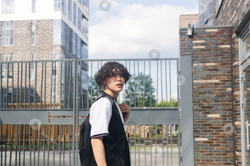 Скачать young man on the street against the urban landscape фотосток Ozero