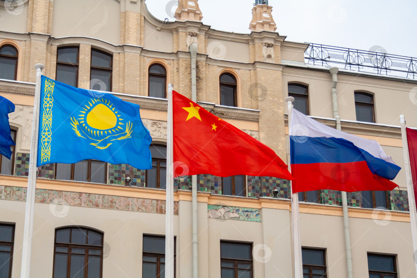 Скачать View of the fluttering flags of China, Russia, and Kazakhstan фотосток Ozero