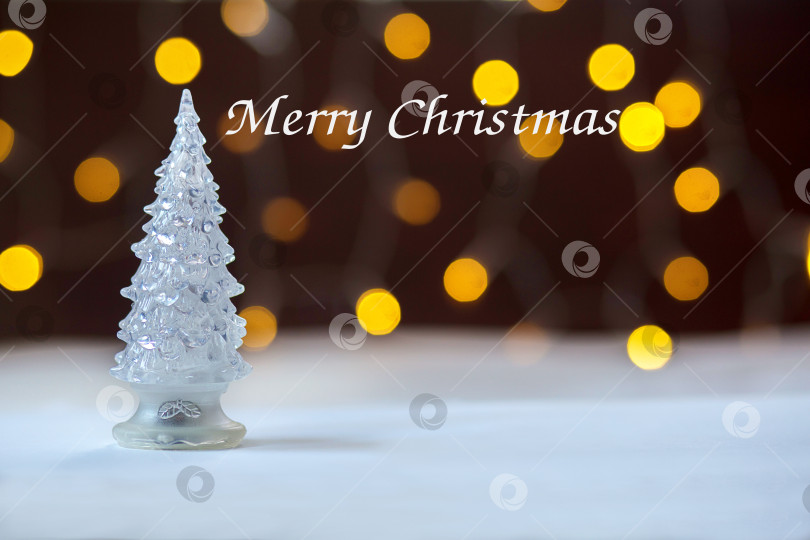 Скачать Новогодняя игрушечная елка на фоне желтых костров. Боке, надпись "Счастливого Рождества" фотосток Ozero