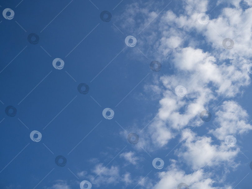 Скачать Летнее голубое небо и белые облака. Фон голубого неба с белыми облаками. Прекрасный облачный покров в солнечное безветренное время года. Панорамный ярко-голубой облачный пейзаж в естественной среде обитания фотосток Ozero
