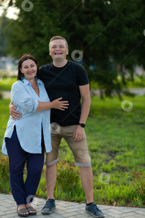 Скачать Муж и жена гуляют по парку, счастливо смеются, обнимаются фотосток Ozero