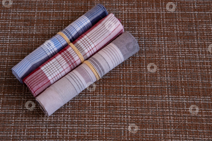 Скачать Three colored handkerchiefs lie nearby. фотосток Ozero