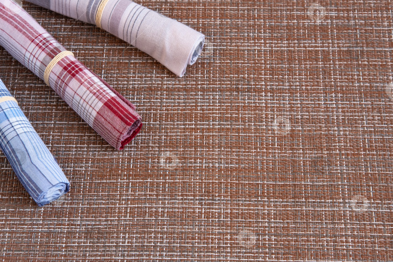 Скачать Three colored handkerchiefs lie in the corner. фотосток Ozero