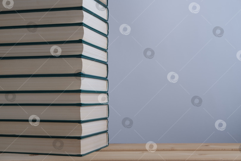 Скачать A stack of books on the table and a light background. фотосток Ozero