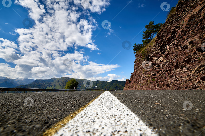 Скачать Белая линия на дороге, разделяющая скалы и голубое небо фотосток Ozero
