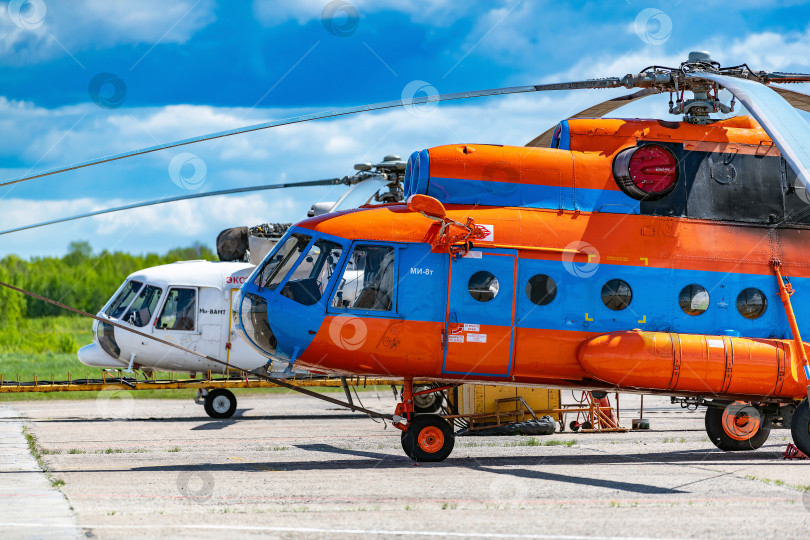 Скачать Вологда, Россия, 07 июня 2022 года Пассажирский вертолет Ми-8 на посадочной площадке в аэропорту ожидает дозаправки, технического обслуживания. фотосток Ozero