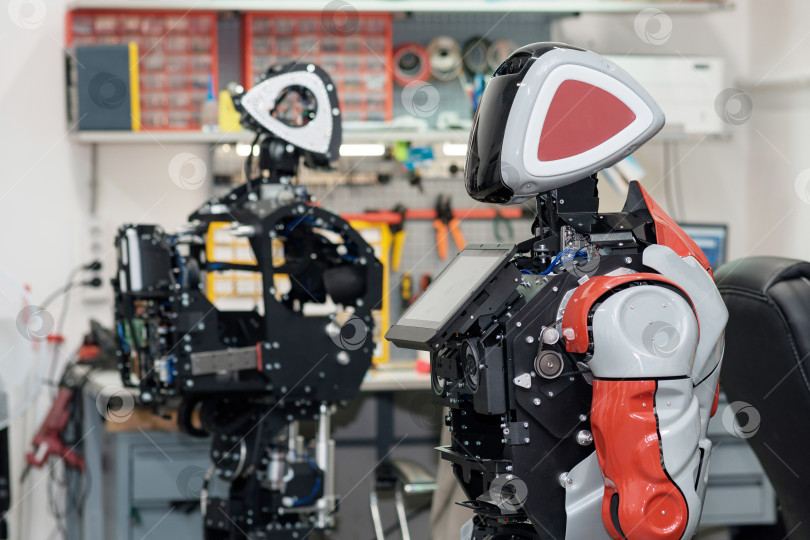 Скачать человекоподобные роботы в процессе сборки и наладки в мастерской фотосток Ozero