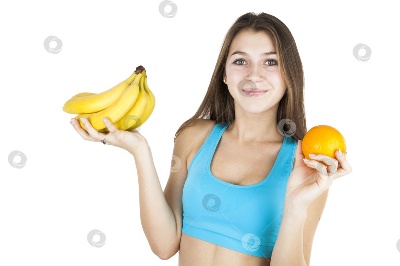 Скачать Спортивная девушка с фруктами в руках фотосток Ozero