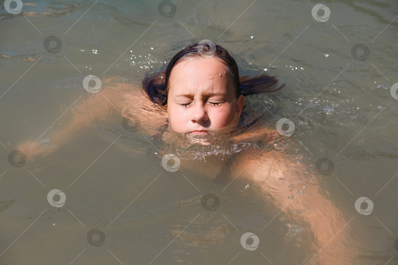 Скачать Девушка плавает в воде крупным планом фотосток Ozero