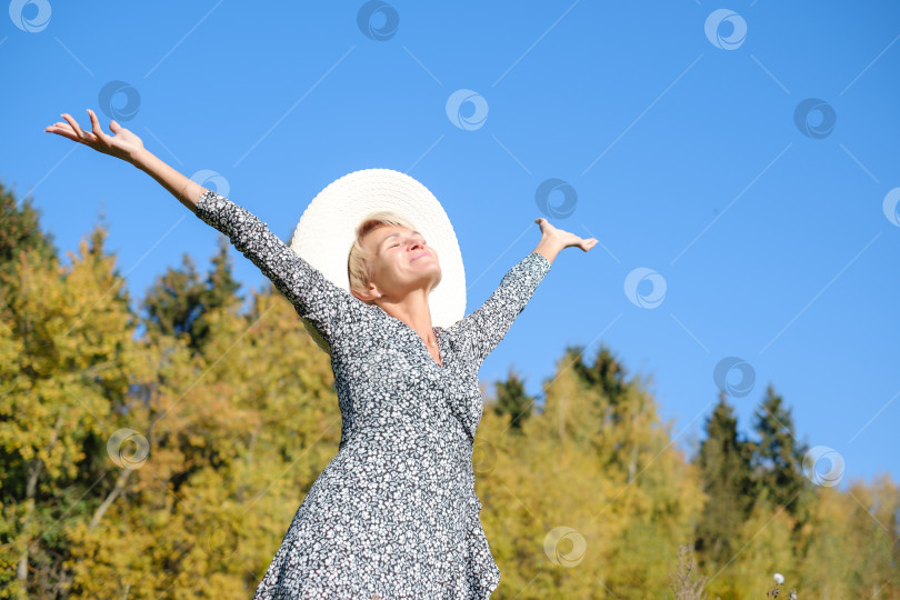 Скачать женщина в платье и шляпе на фоне осенних деревьев и голубого неба в солнечный день фотосток Ozero