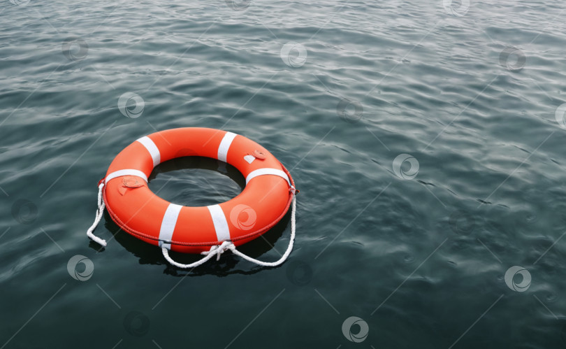 Скачать ярко-оранжевый круг плавает в голубой океанской воде фотосток Ozero