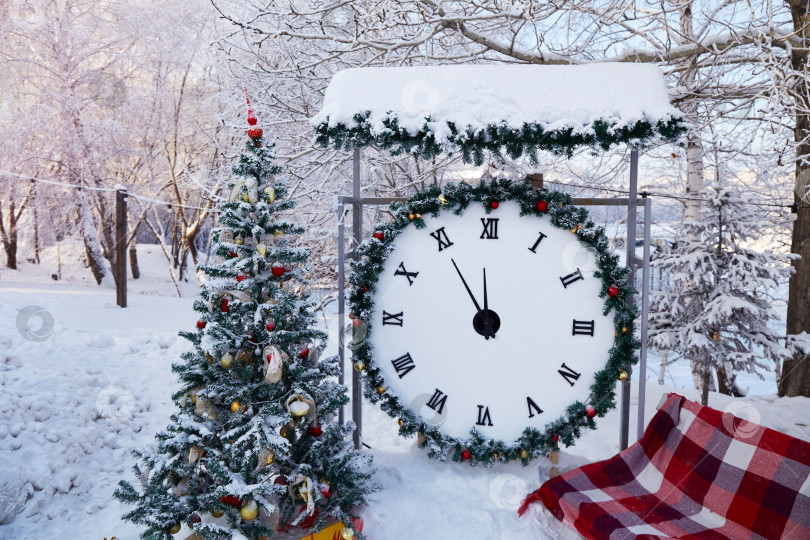 Скачать Рождественская елка с игрушками, огромные часы в городском парке зимой. фотосток Ozero