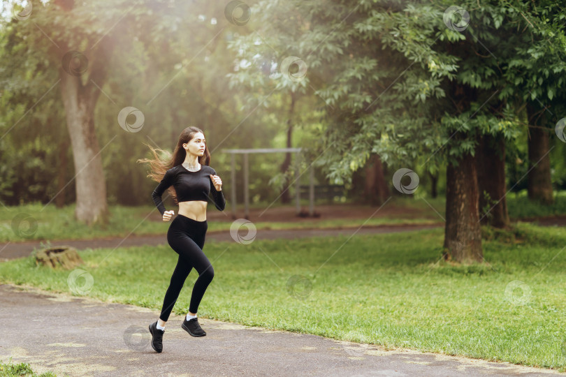 Скачать Молодая женщина в спортивной одежде занимается утренней пробежкой на открытом воздухе. Концепция здорового образа жизни фотосток Ozero