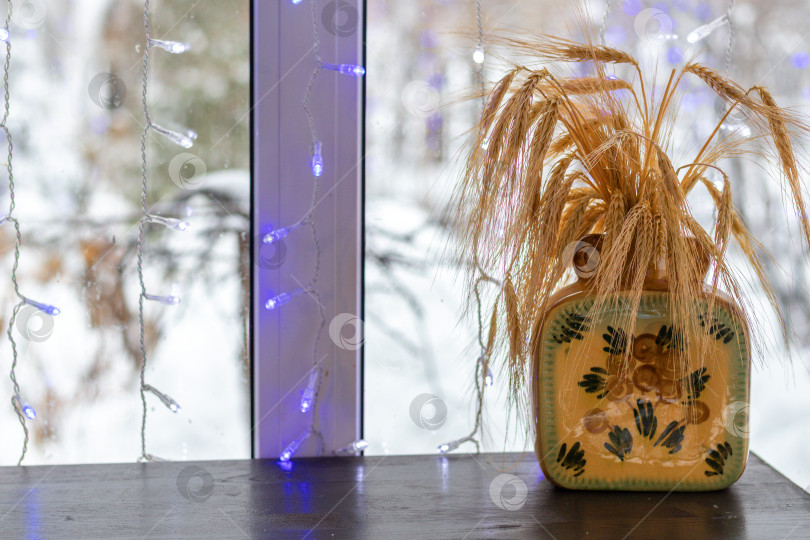 Скачать букет из колосьев пшеницы на столике кафе на фоне зимы. Рождественский натюрморт. Пространство для копирования фотосток Ozero
