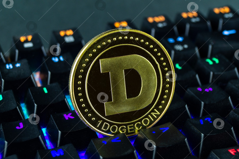 Скачать Монета криптовалюты dogecoin крупным планом клавиатуры с цветовой кодировкой фотосток Ozero