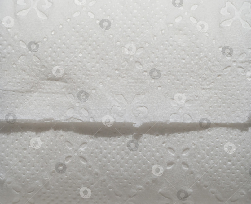 Скачать Фон из текстурированной бумаги. Макросъемка текстуры поверхности туалетной бумаги фотосток Ozero