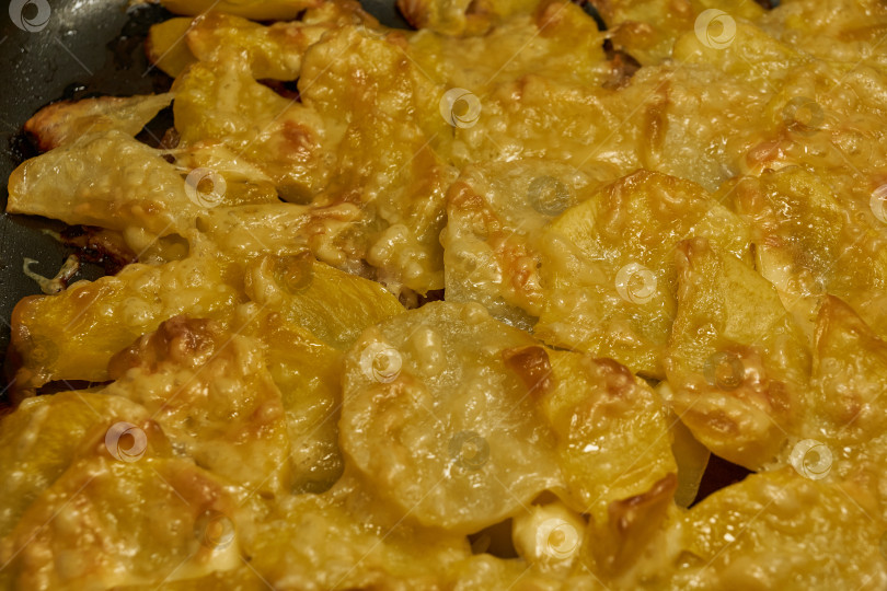 Скачать Запеченные ломтики картофеля с сыром в духовке. фотосток Ozero