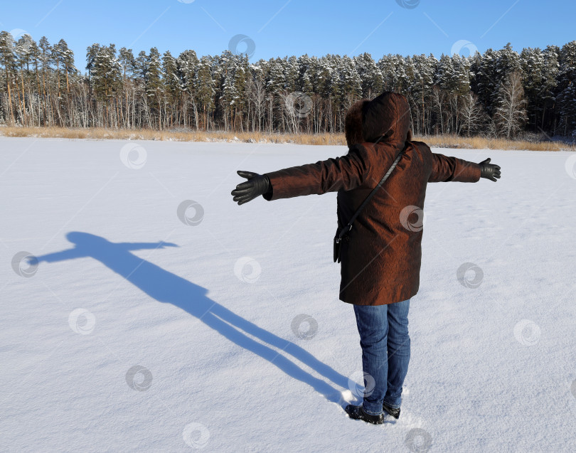 Скачать женщина и ее тень на заснеженном замерзшем озере. фотосток Ozero
