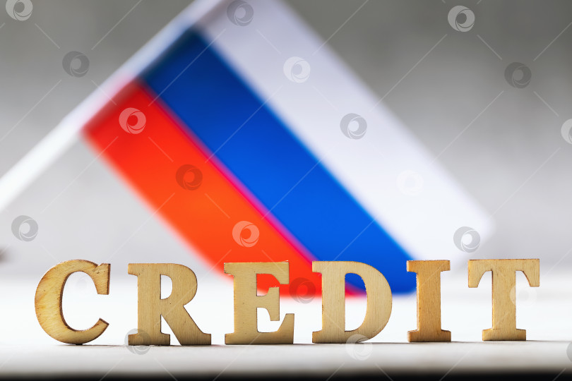 Скачать Текст из деревянных букв и российский флаг на абстрактном фоне, концепция на тему долгового бремени народа России фотосток Ozero