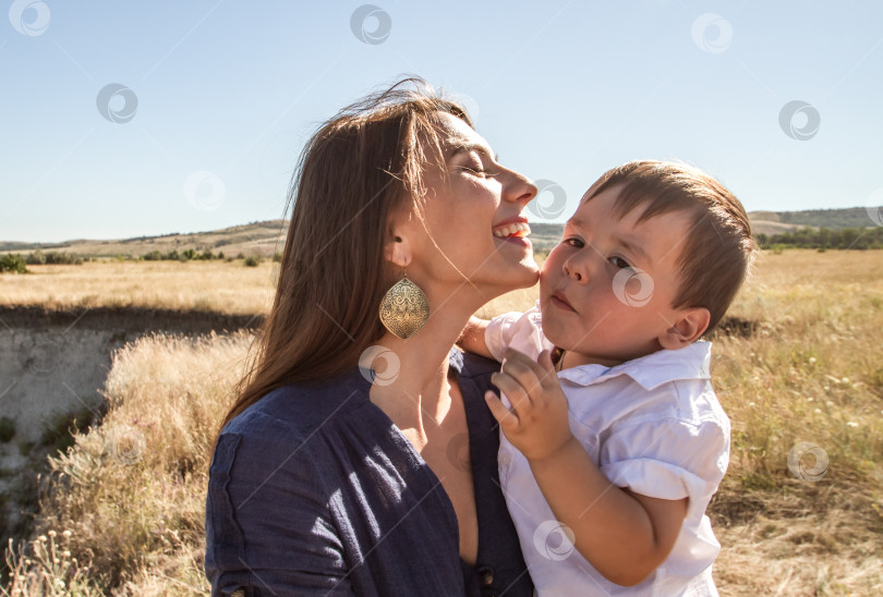 Скачать Счастливая молодая женщина обнимает ребёнка. фотосток Ozero