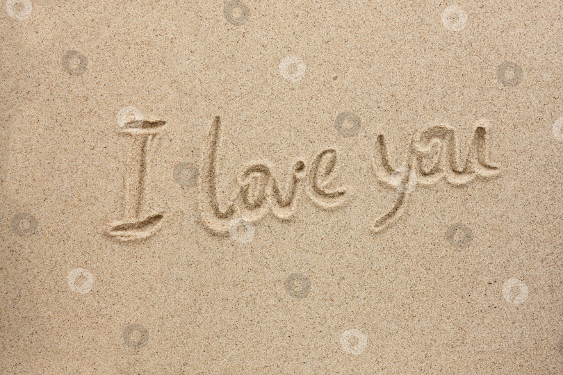 Скачать Фраза я тебя люблю, написанное на песке в качестве фона. Слово "я люблю тебя", написанное на песке в качестве фона фотосток Ozero