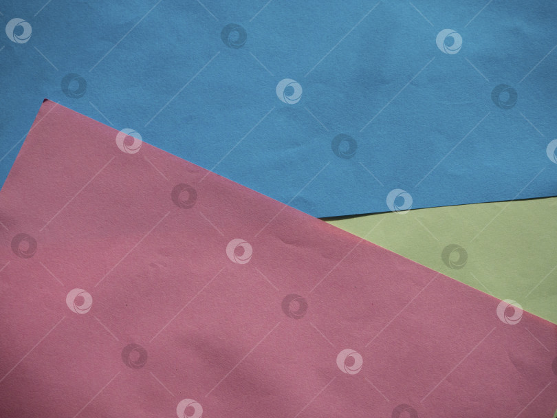 Скачать Разноцветный фон из нескольких листов цветной бумаги фотосток Ozero