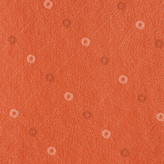 Скачать Синтетическая кожа оранжевого цвета для фона. Крупный план текстуры отделочного материала, рисунка фотосток Ozero