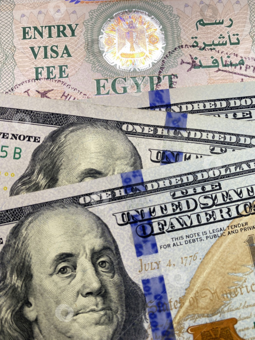 Скачать Фон: купюры долларов США на фоне визы в Египет в паспорте. фотосток Ozero