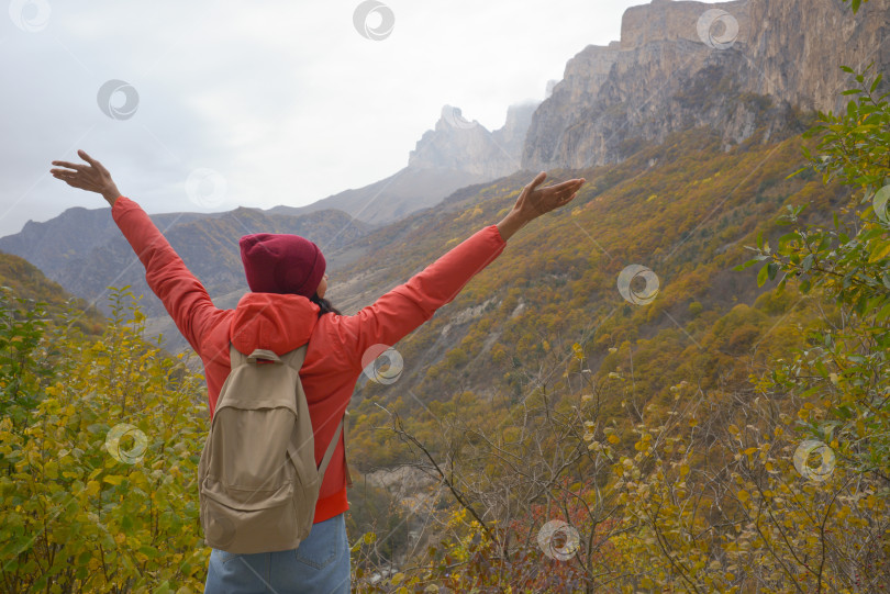 Скачать Женщина на природе, исследующая Кавказские горы в России, путешествия, стиль жизни, пеший туризм, девушка-путешественница подняла руки, активные осенние каникулы, пеший туризм фотосток Ozero