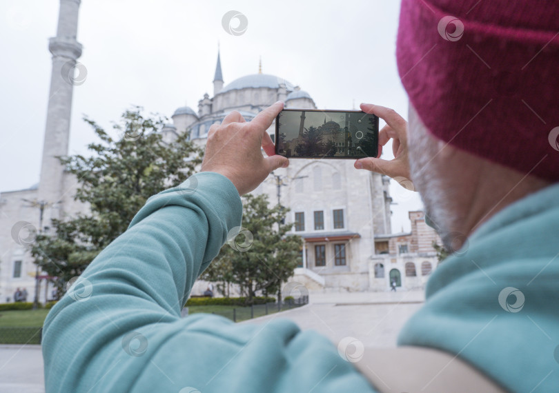 Скачать Турист мужского пола фотографирует мечеть Фатих в Стамбуле, Турция, на память. фотосток Ozero