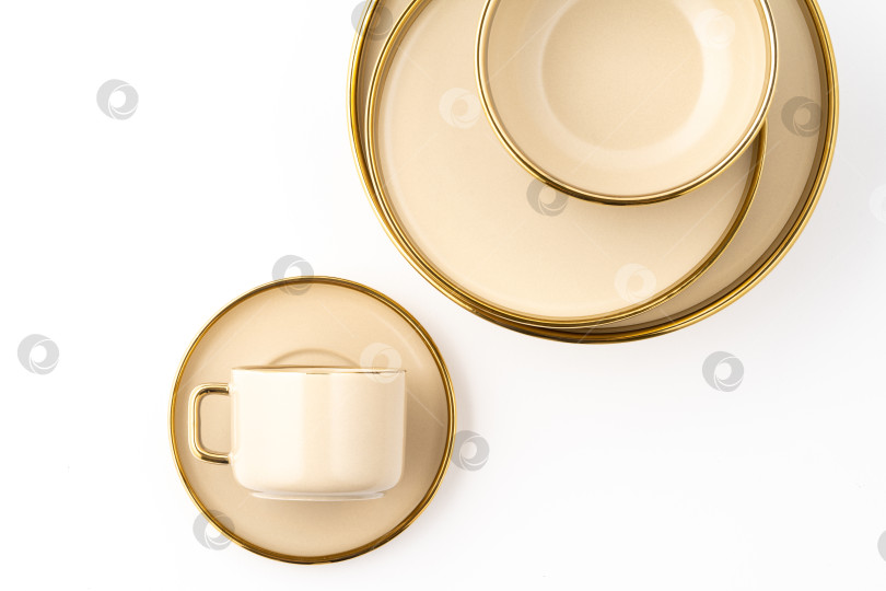 Скачать Набор из светло-коричневой керамической тарелки и чашки на белом фоне. Вид сверху фотосток Ozero