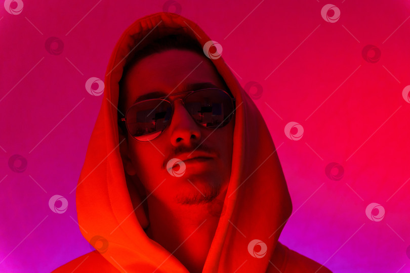 Скачать Студийный портрет мужчины-модели с усами и бородой крупным планом на красном фоне в солнцезащитных очках фотосток Ozero