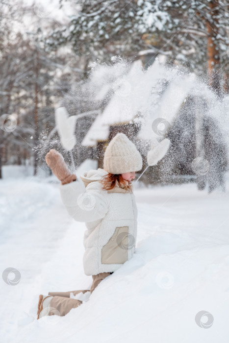 Скачать Девушка подбрасывает снег зимой. фотосток Ozero