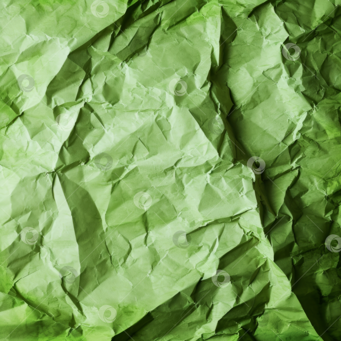 Скачать Текстура мятой зеленой бумаги, абстрактный фон для концепций экологичности или вторичной переработки. фотосток Ozero