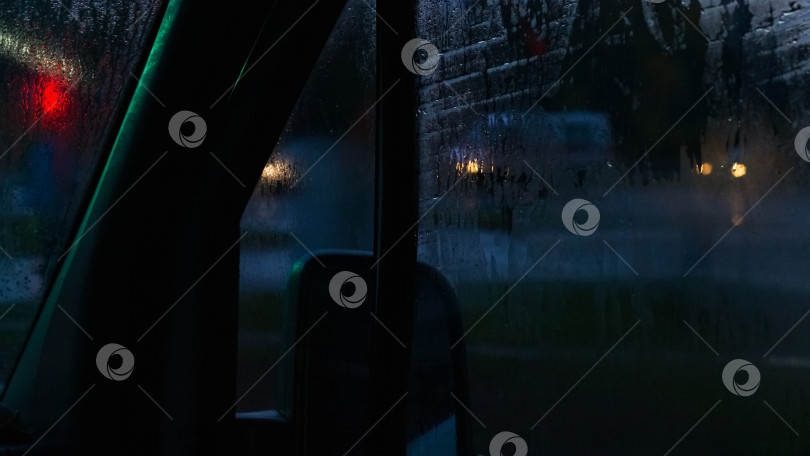 Скачать Боковое стекло автомобиля ночью с каплями дождя фотосток Ozero