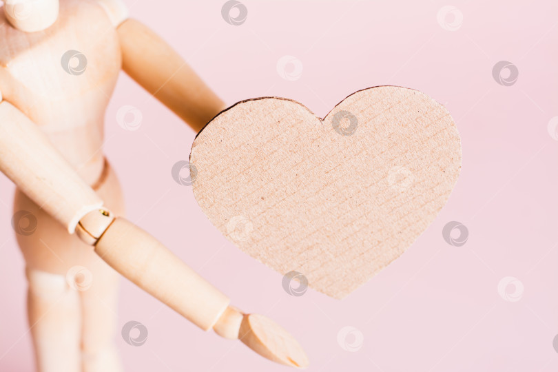 Скачать Создайте картонное сердечко деревянными руками на розовом фоне copy space фотосток Ozero