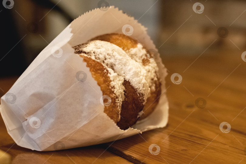 Скачать Пончики с сахарной пудрой на деревянном столе фотосток Ozero