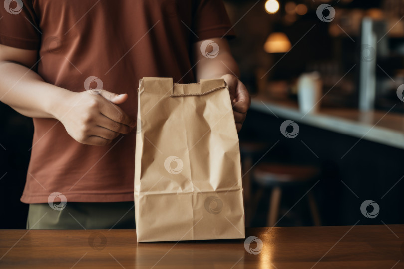 Скачать Крупный план мужчины с коричневым бумажным пакетом на фоне кафе в размытом виде. Макет фотосток Ozero
