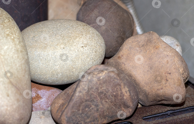 Скачать на раскаленных камнях в сауне для пара и тепла железная печь в бане обложена серыми камнями фотосток Ozero