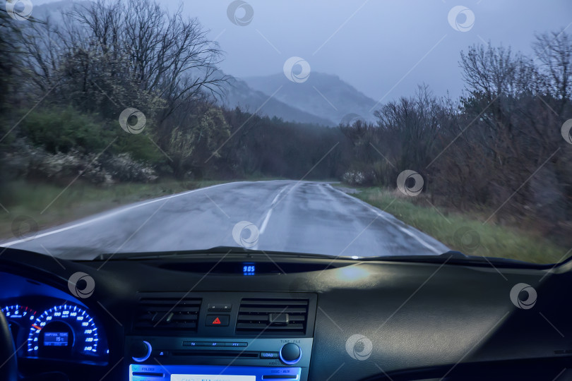 Скачать Вид через лобовое стекло автомобиля на мокрую дорогу фотосток Ozero