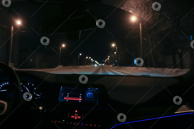 Скачать автомобиль движется по улице города зимней ночью. фотосток Ozero