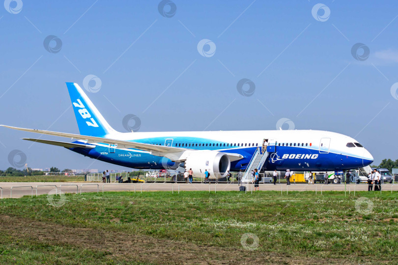 Скачать Boeing 787 Dreamliner - широкофюзеляжный двухмоторный турбореактивный пассажирский самолет на статической стоянке МАКС-2011. Трап установлен с правой стороны фюзеляжа. фотосток Ozero