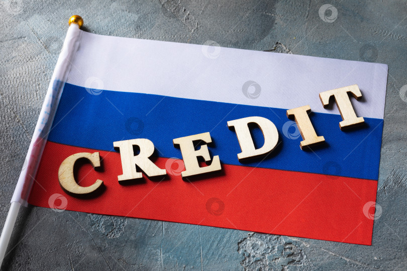 Скачать Текст из деревянных букв и российского флага на абстрактном фоне, концепция на тему использования кредита в России фотосток Ozero