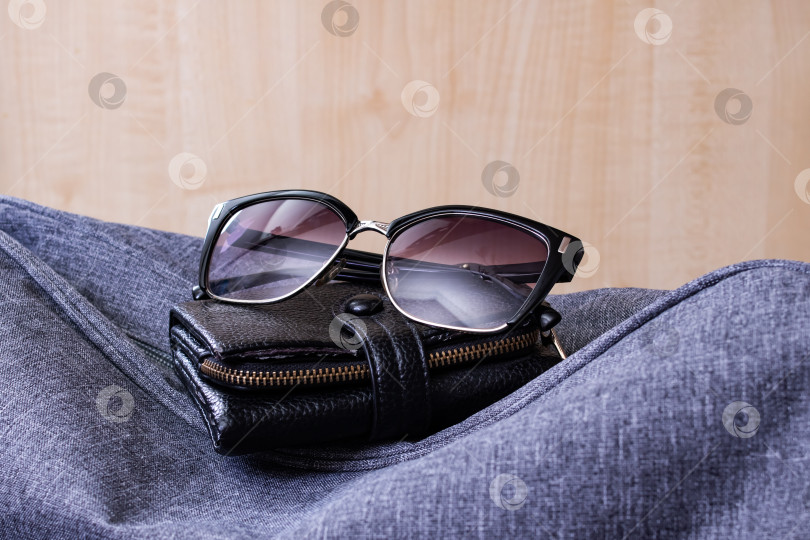 Скачать Бумажник, солнцезащитные очки и дорожная сумка на деревянном фоне фотосток Ozero