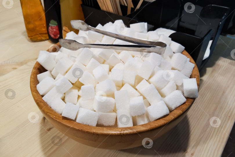 Скачать Кубики сахара в деревянной миске на столе фотосток Ozero
