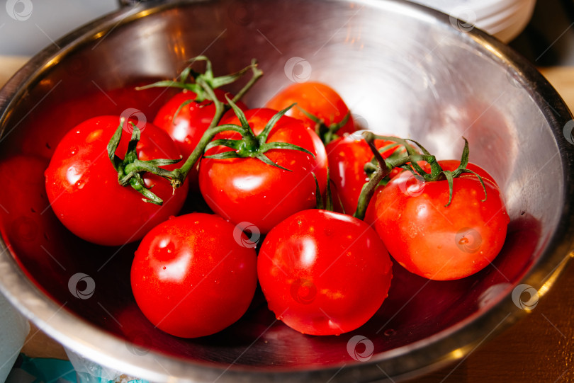 Скачать Свежие спелые помидоры на лозе в миске из нержавеющей стали фотосток Ozero